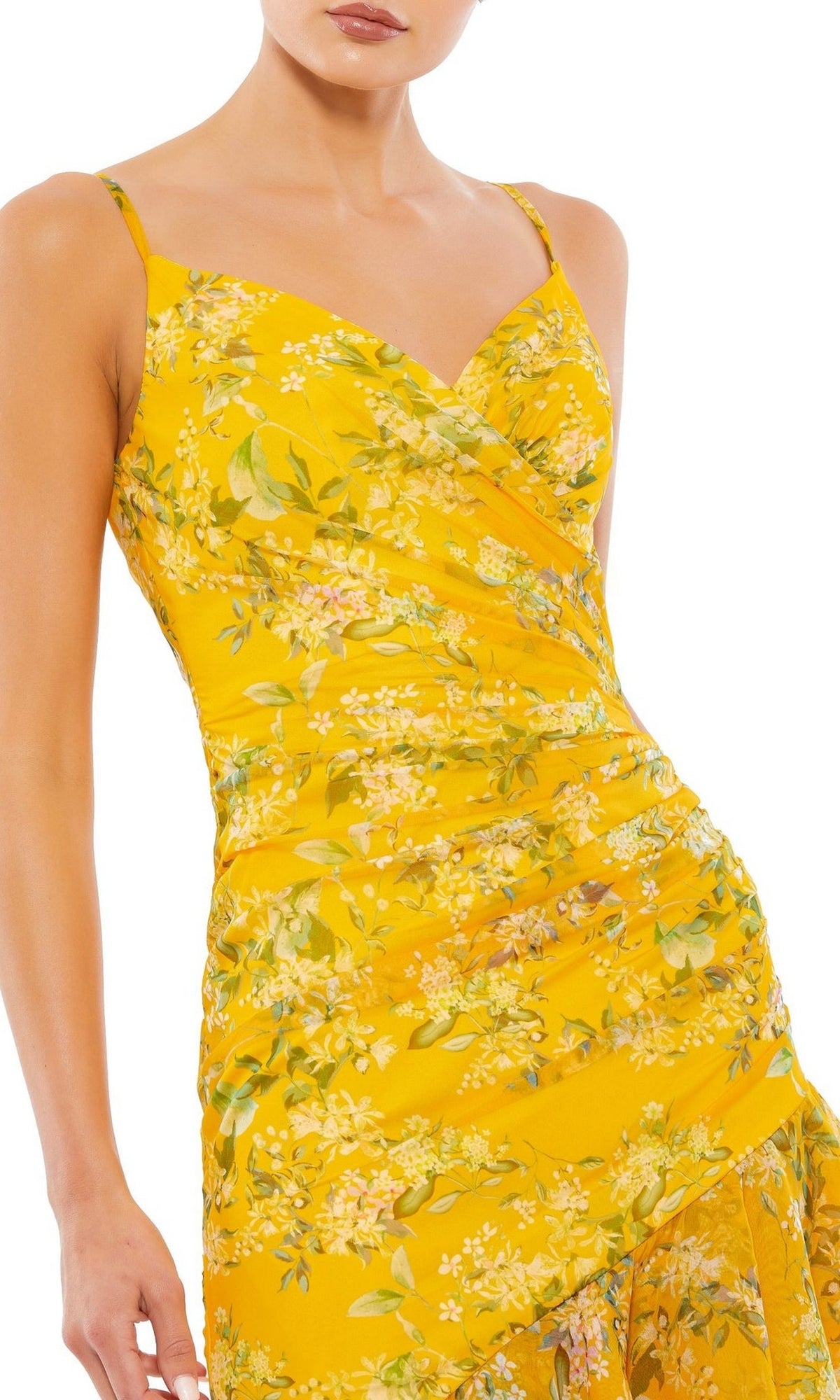 A woman wears the Mac Duggal 70202 Yellow Print High-Low Party Dress, featuring thin straps and a ruched, wrap-style bodice—an ideal chic choice for cocktail parties.